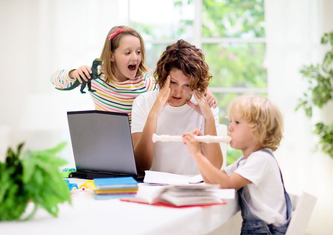 Photo of kids pestering work-from-home mom