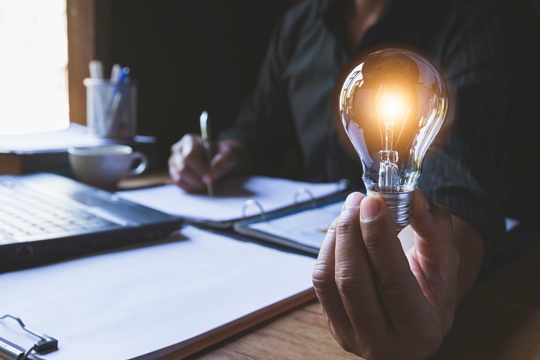 Business professional holding a lightbulb